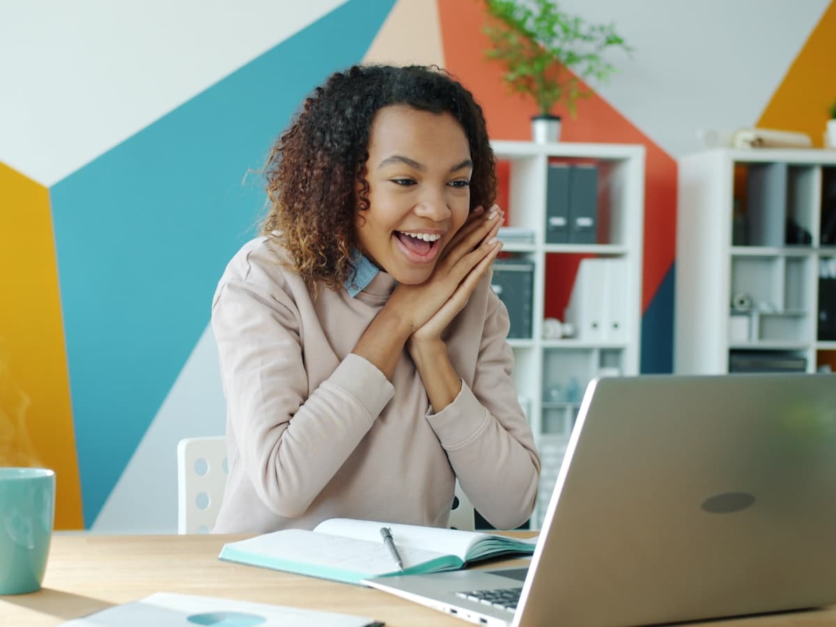 Someone working at a bright desk, laptop open